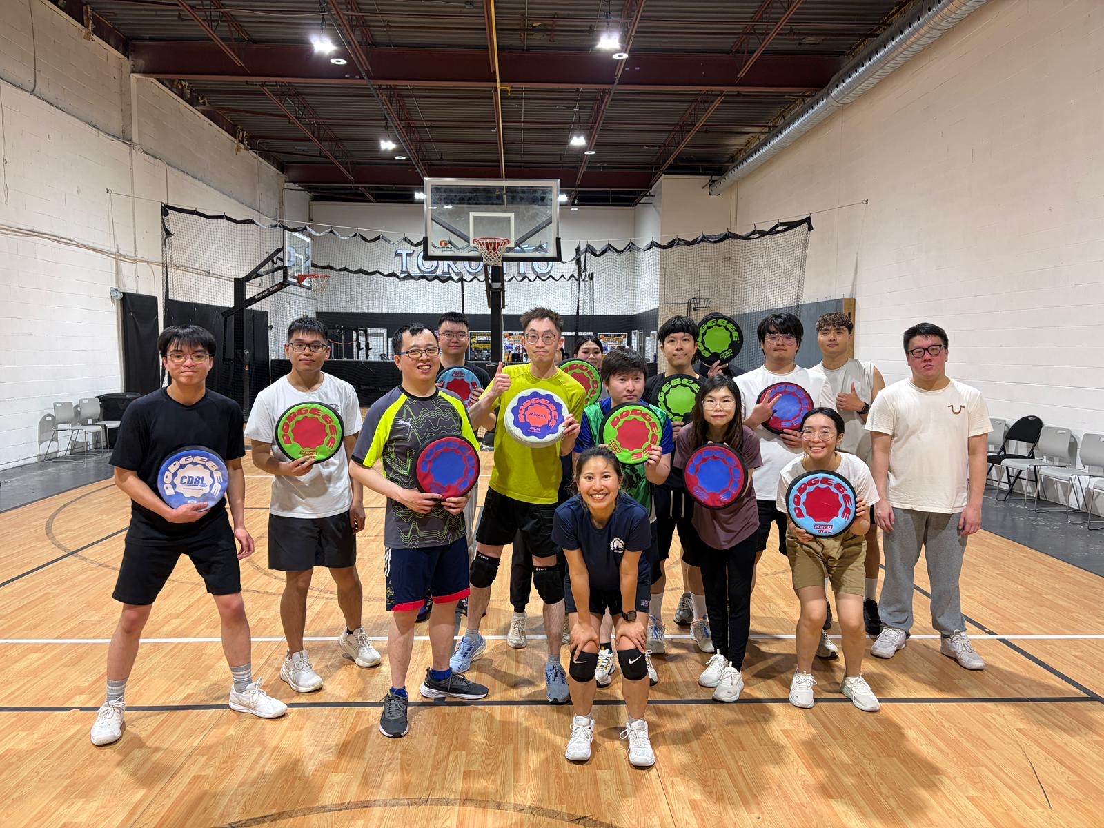 Toronto Dodgebee players gather on an indoor court holding soft flying discs.